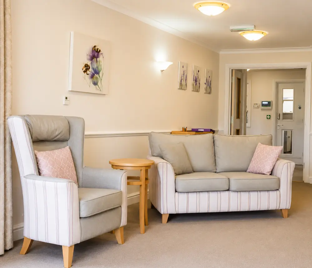 Comfortable communal lounge at Avon Lodge nursing and dementia care home in Kingswood, Bristol, with armchairs and sofa seating.