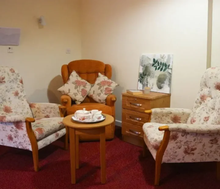 Communal lounge with comfortable seating at Ladymead Nursing Home in Swindon