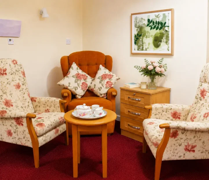 Communal lounge with comfortable seating at Ladymead Nursing Home in Swindon