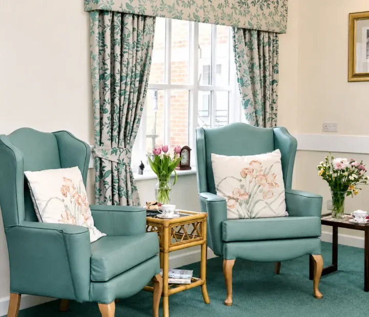 Comfortable lounge area at Ladymead nursing and residential care home in Swindon, with armchairs and homely furnishings.