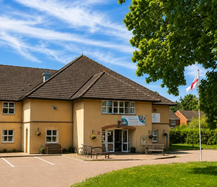 Exterior of Oaktree care home in Yate, Bristol, with landscaped grounds and visitor parking.