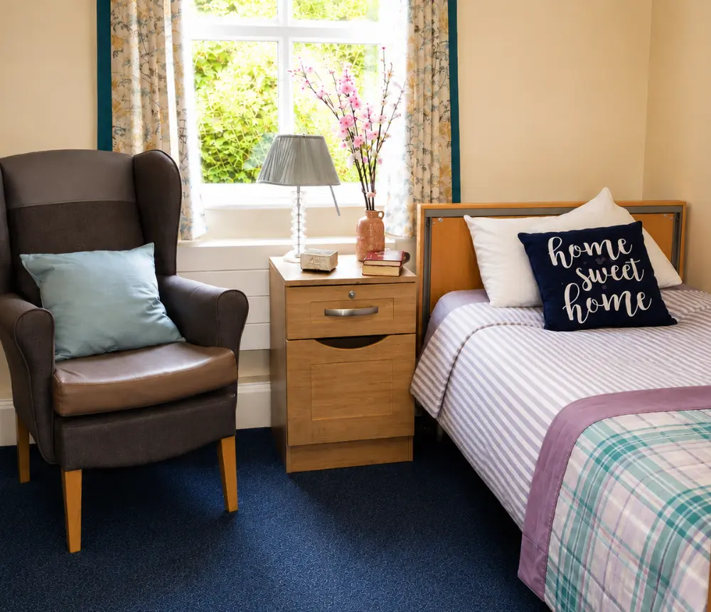 Comfortable furnished bedroom at Oaktree care home in Yate, Bristol.