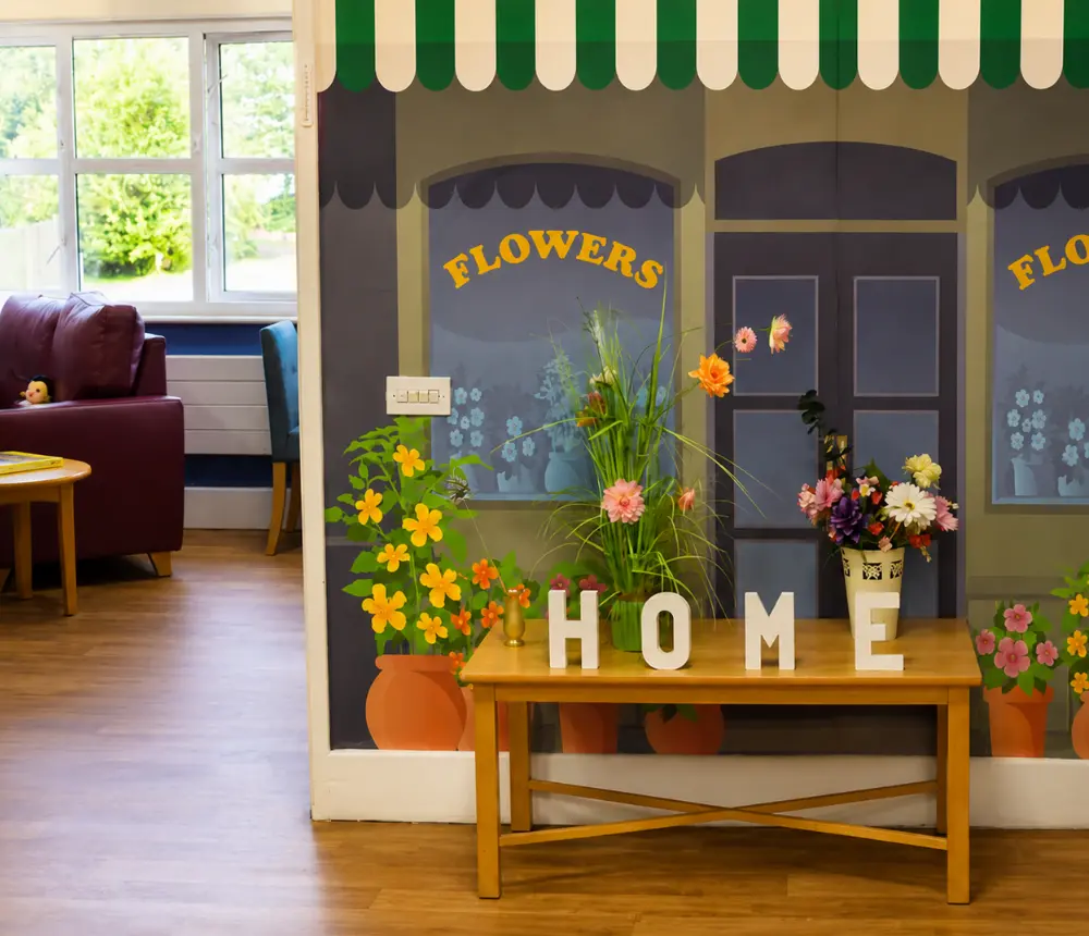 Colourful flower-themed dementia-friendly communal area at Oaktree care home in Yate.