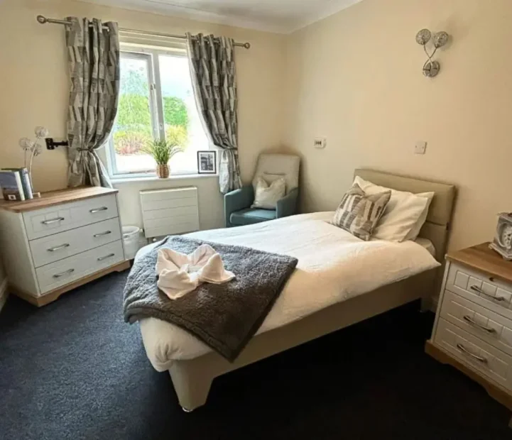 Bright and comfortable resident bedroom at Olive House care home in Newton Flotman