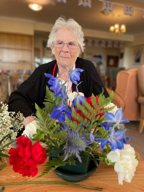 Happy Tenchley Manor's resident making a flower arrangement