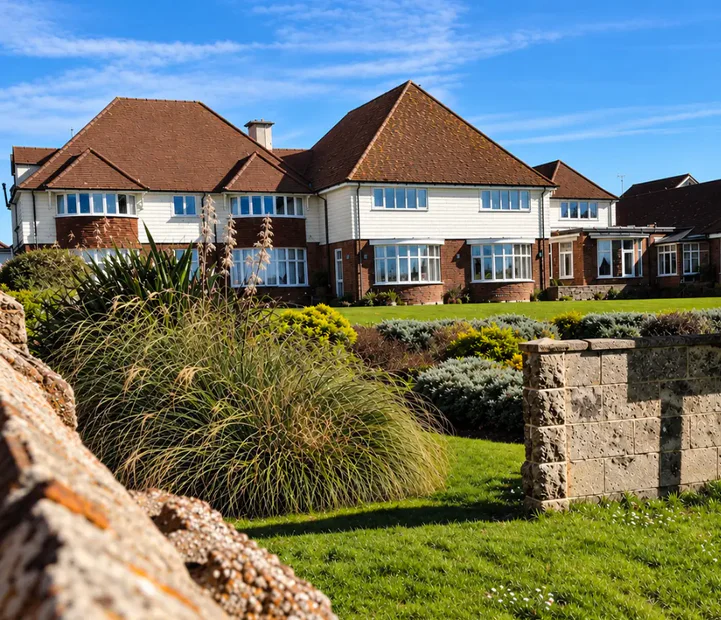 Exterior of Tenchley Manor residential and nursing care home in Chichester, with gardens and established planting.