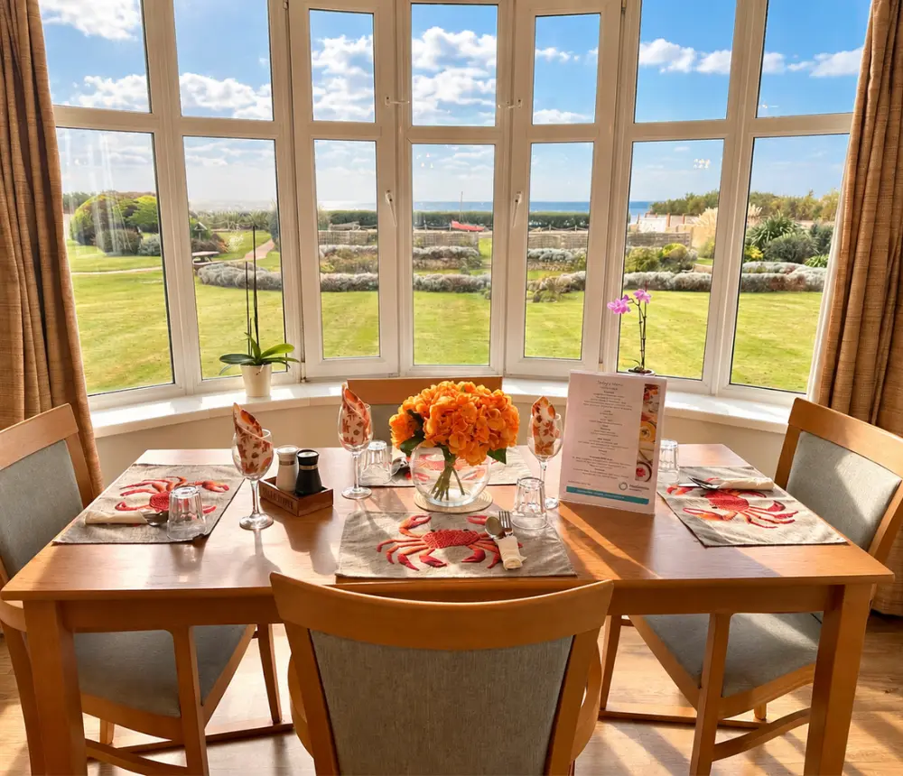 Dining table overlooking the gardens at Tenchley Manor care home in Chichester.