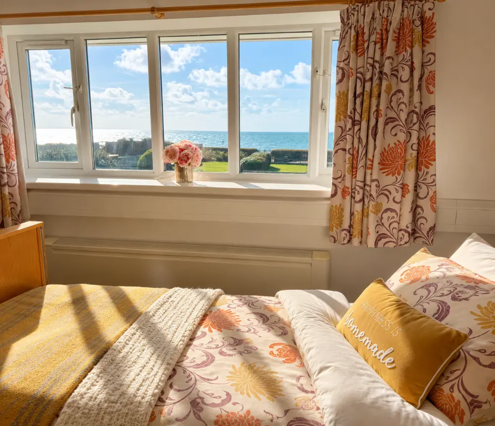 Coastal views through a bedroom window at Tenchley Manor care home in Chichester.