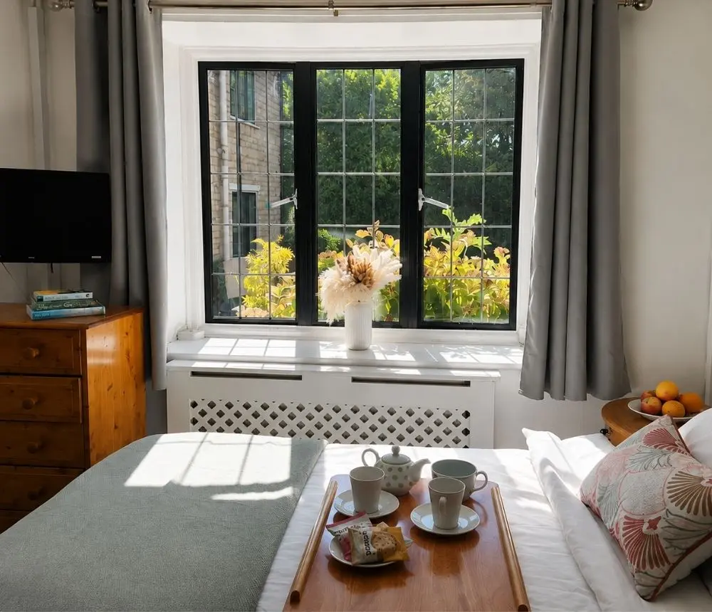 Bright, comfortable bedroom at The Malthouse care home in Gillingham.