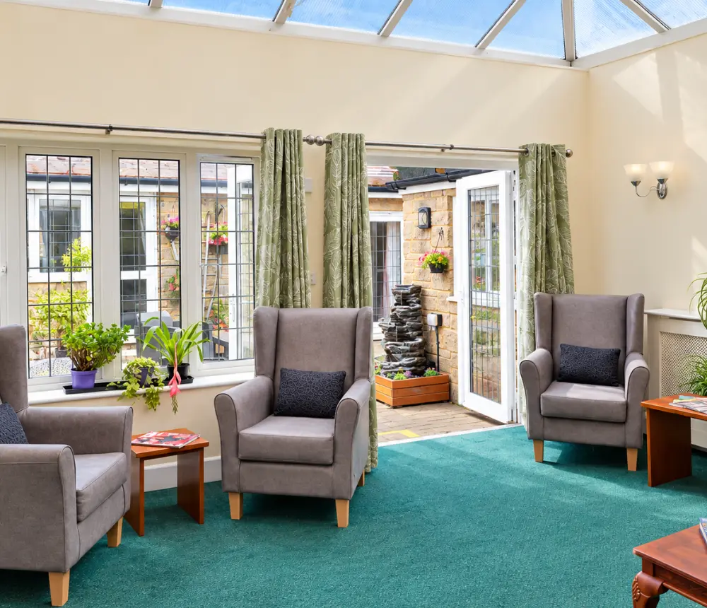 Bright conservatory lounge at The Malthouse care home