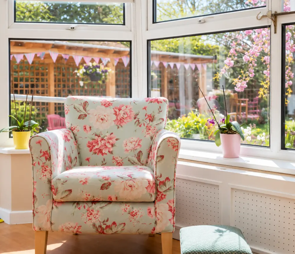 Floral armchair overlooking the garden at The White House care home in Beccles.