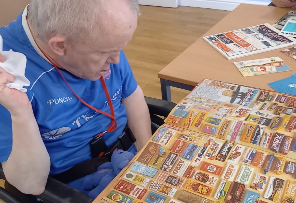 Handford House’s Trip Down Memory Lane - Resident David looking through a catalogue of nostalgic food packaging.