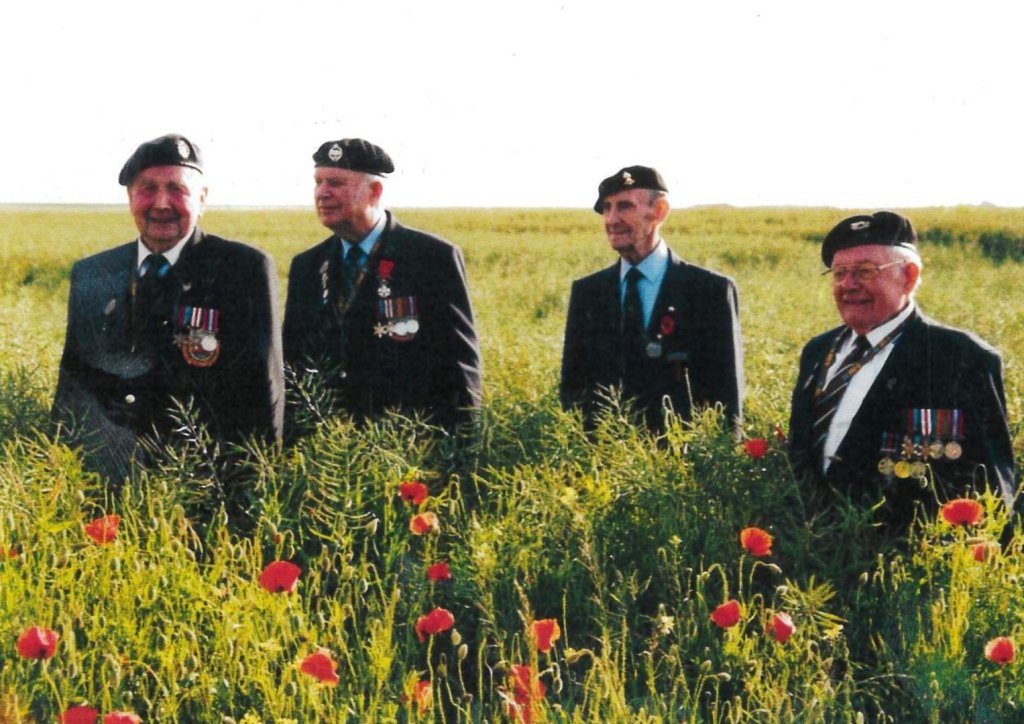 David in poppyfield with fellow veterans | Saxlingham Hall care home