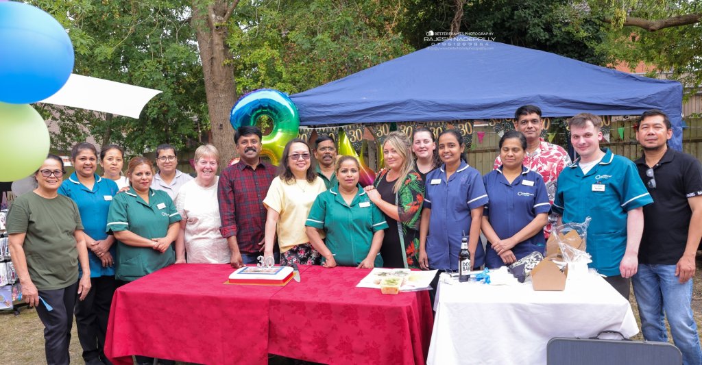 The team at Ladymead Care Home in Wroughton, Swindon smiling together during the 30th anniversary summer fete, celebrating with residents, families, and the local community.