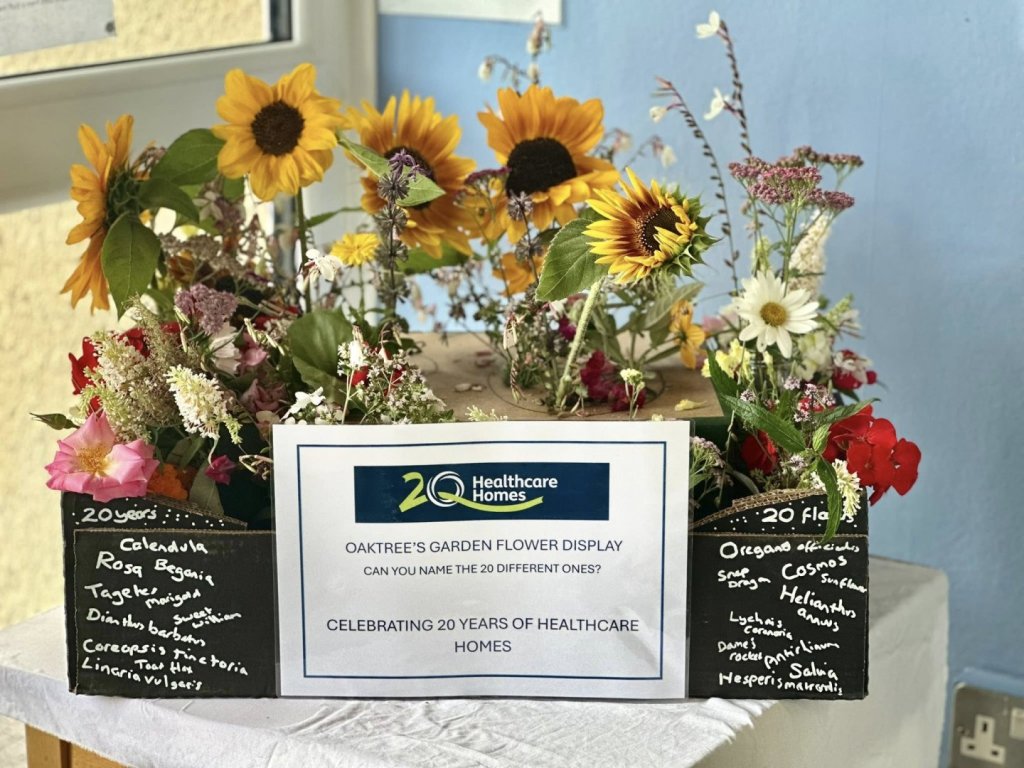 Oaktree care home garden display featuring 20 different flowers, created to celebrate 20 years and win the 20 Years InBloom Award.