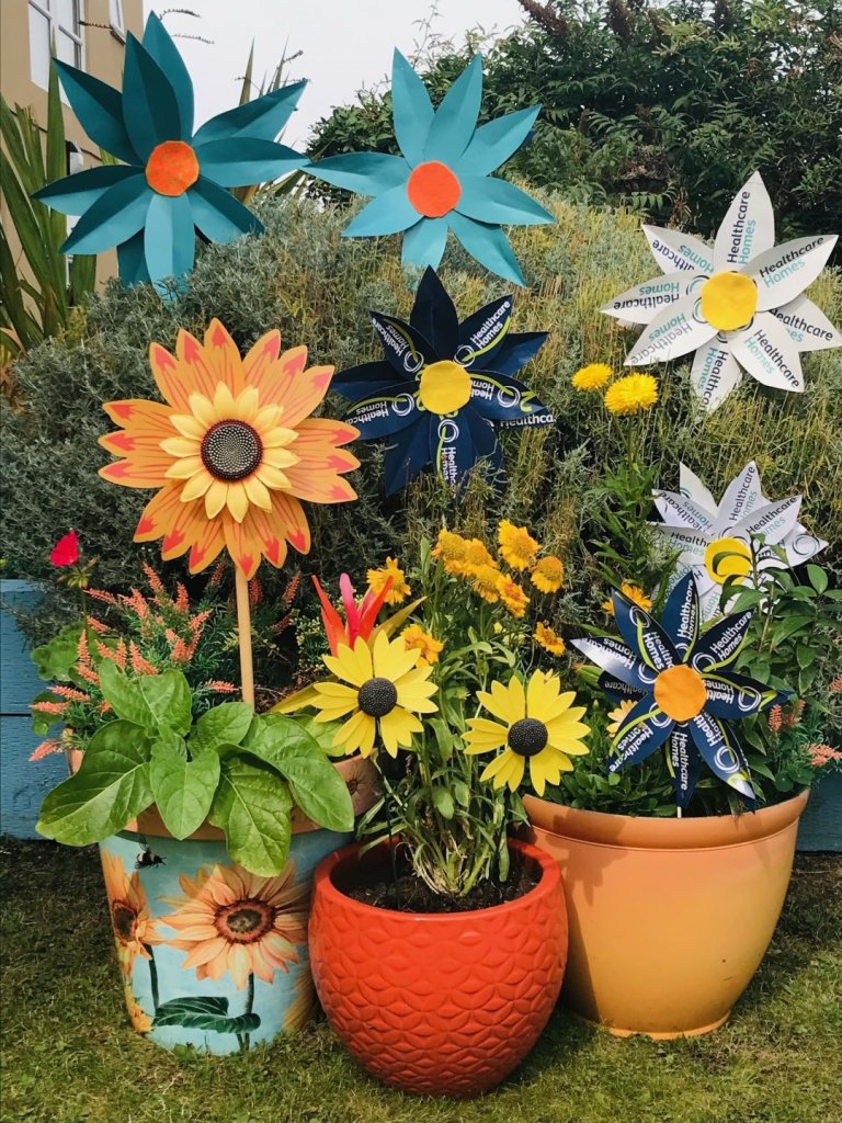 Colourful flower display created from repurposed 20th anniversary bunting by residents at Sandown Park Care Home.