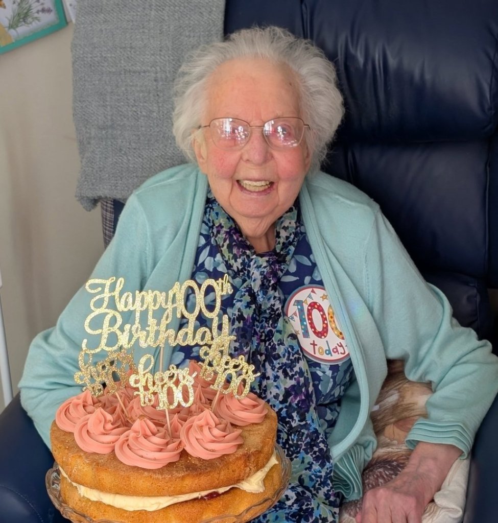 Joyce Newstead, 100, holding her birthday cake during celebrations at The Manor House care home in North Walsham.