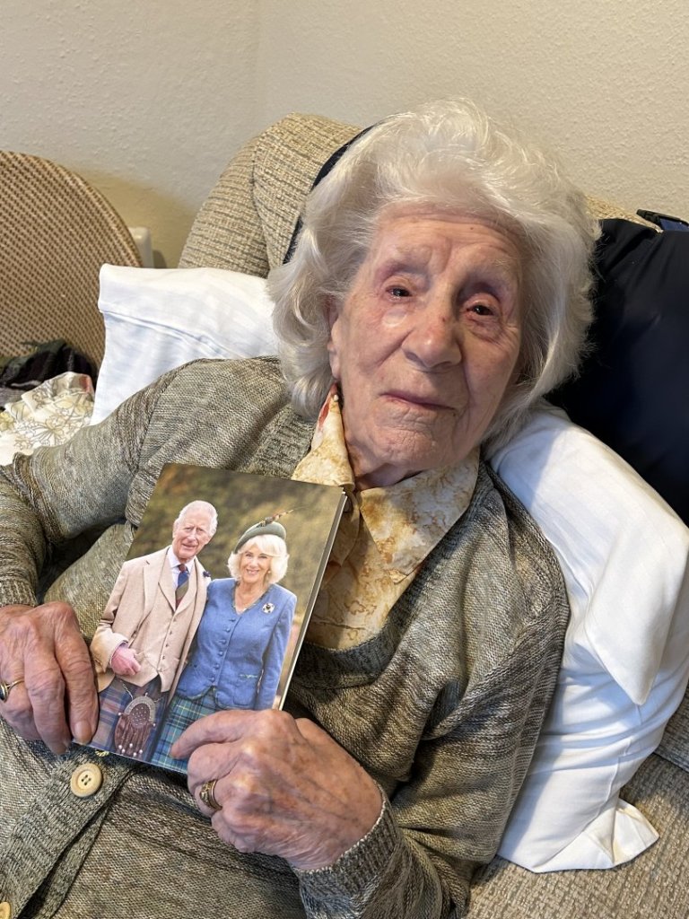Kathleen Bultitude celebrating her 100th birthday at a North Walsham care home with a card from His Majesty The King