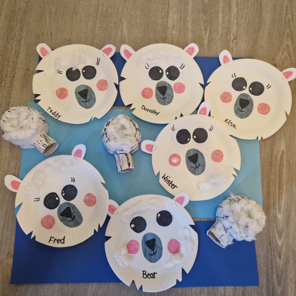 Residents at Bedhampton Court holding handmade polar bears crafted from paper plates to celebrate International Polar Bear Day.
