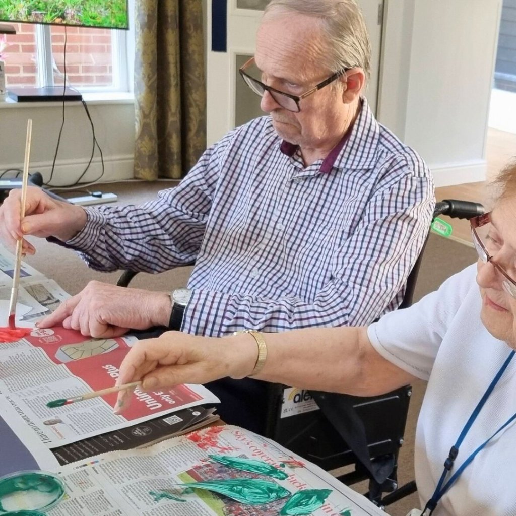 Two residents painting animals for the World Wildlife Day collage at Aldringham Court.