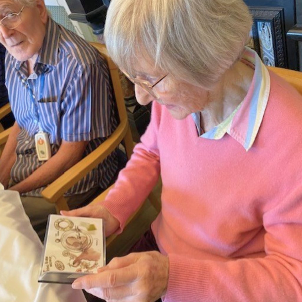 Residents at Uvedale Hall looking at items from the Royal Mint reminiscence box.