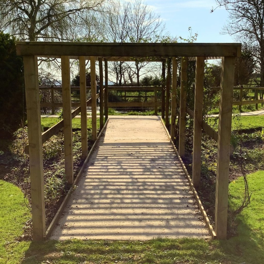 Pergola walkway in The Old Vicarage care home gardens for residents to enjoy.