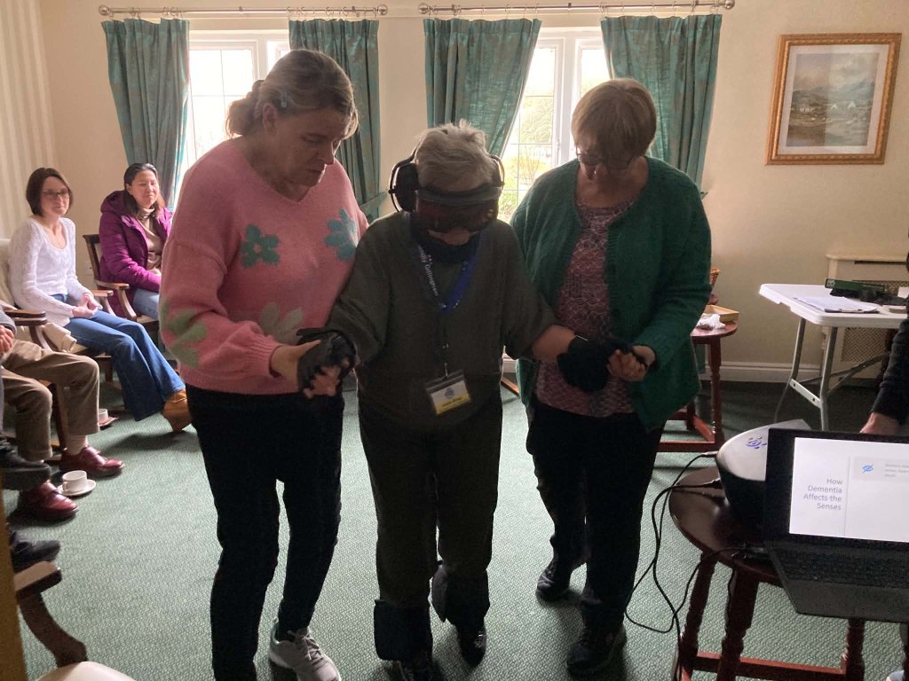 Healthcare Homes colleague wearing a GERT age-simulation suit during training at The Malthouse