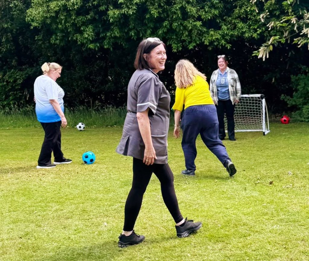 Foxgrove and Maynell House staff taking part in a World Cup football tournament in the garden