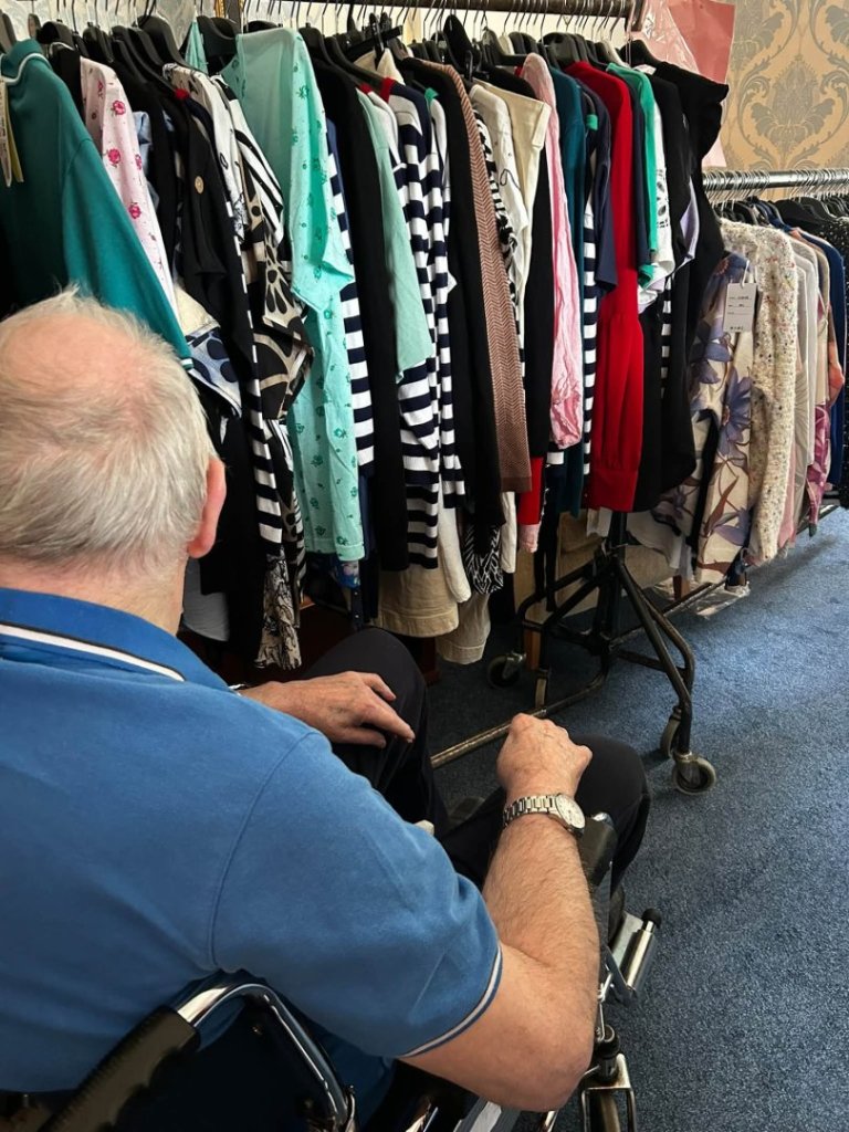 Uvedale Hall resident looks through clothes at the pop-up shop