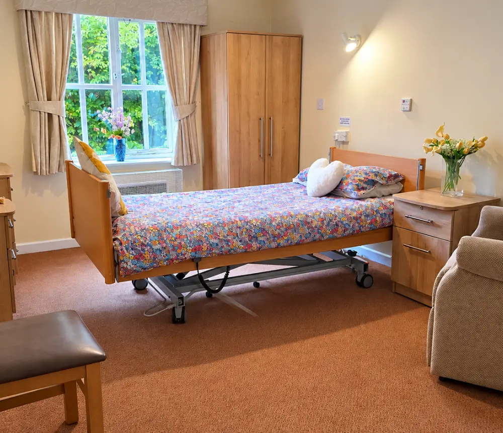 Furnished bedroom at Ladymead care home in Swindon